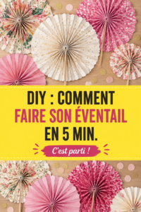 Un éventail DIY coloré fabriqué à la main, posé sur une table en bois.